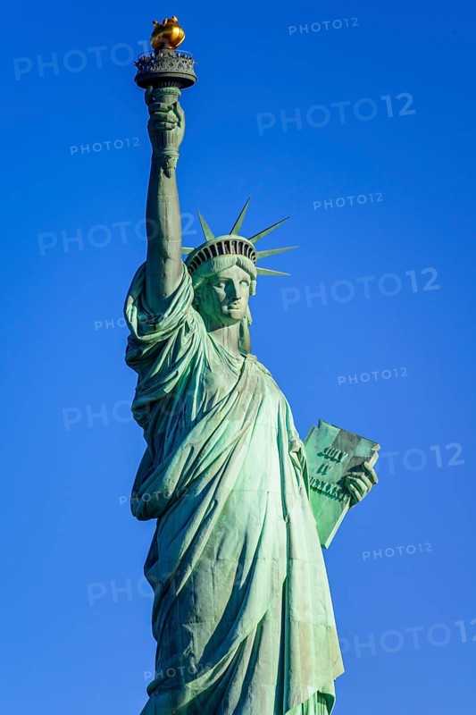 Statue of Liberty in front of blue sky