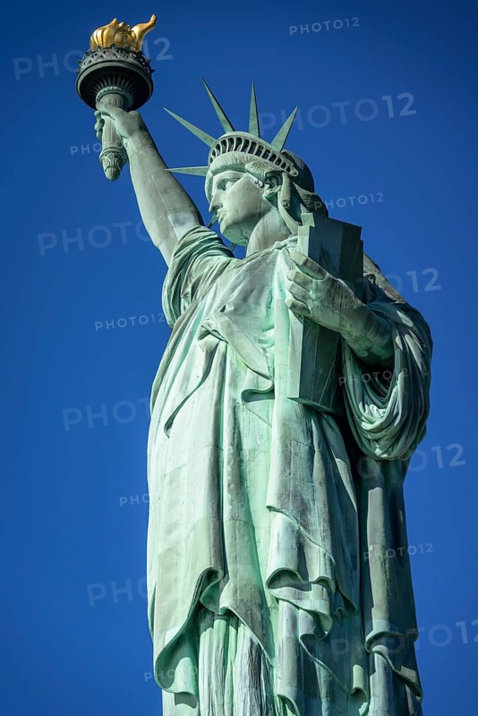 Statue of Liberty in front of blue sky