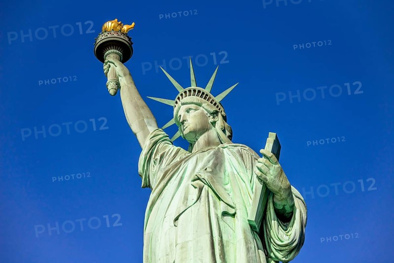 Statue of Liberty in front of blue sky