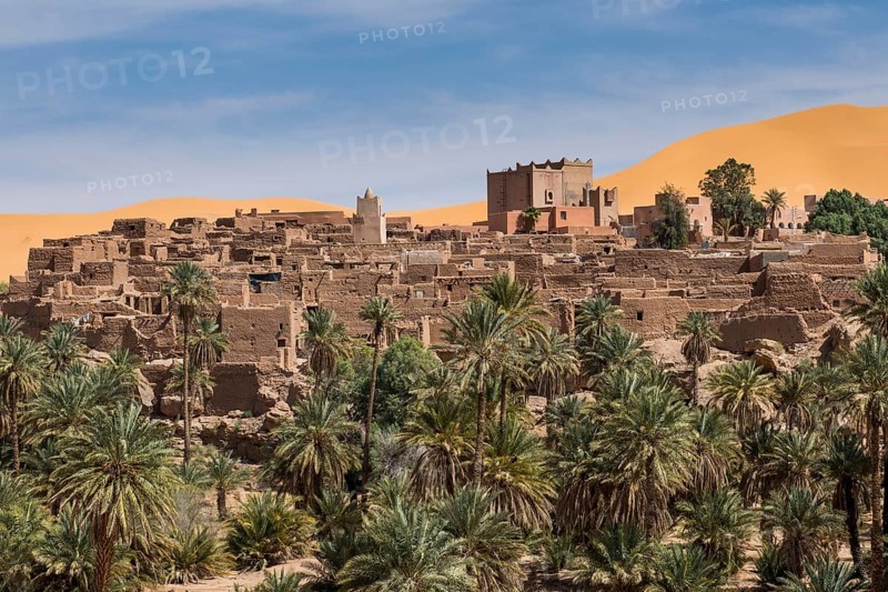 Overlook over the oasis of Taghit with sand dunes