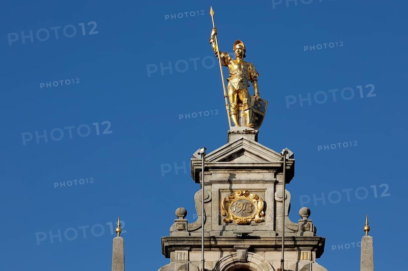 Golden figure with lance on gable of a guild house