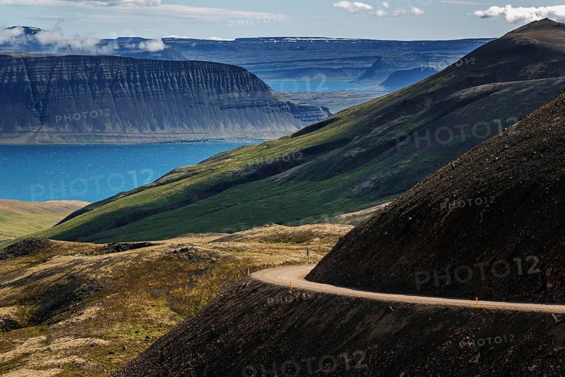 Gravel road meanders through volcanic landscape