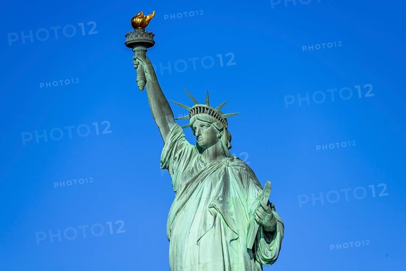 Statue of Liberty in front of blue sky