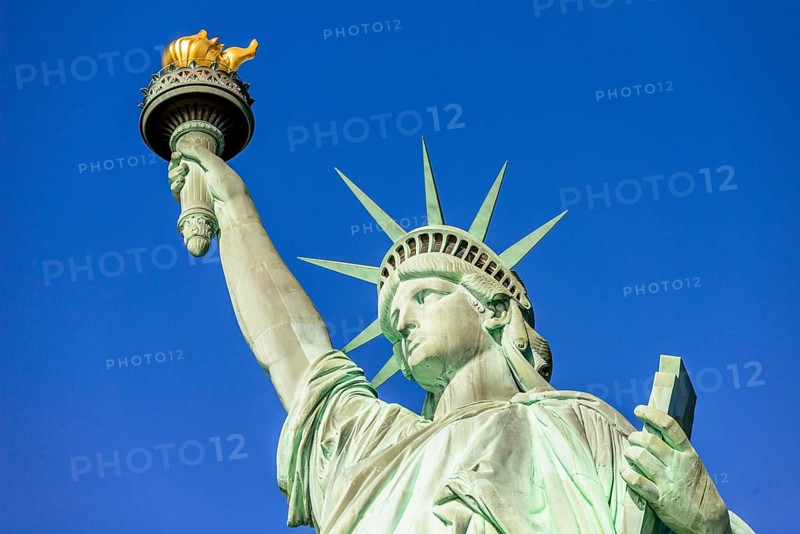 Statue of Liberty in front of blue sky
