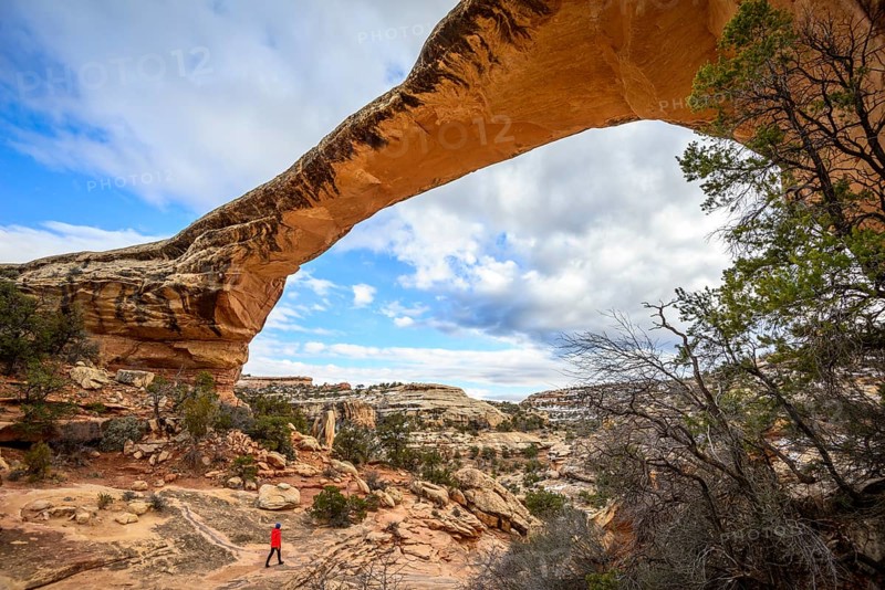 Tourist under rock arch