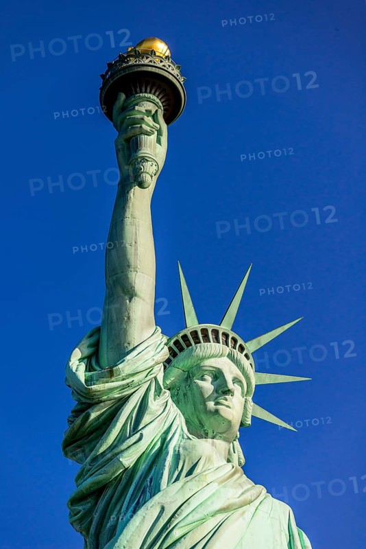 Statue of Liberty in front of blue sky