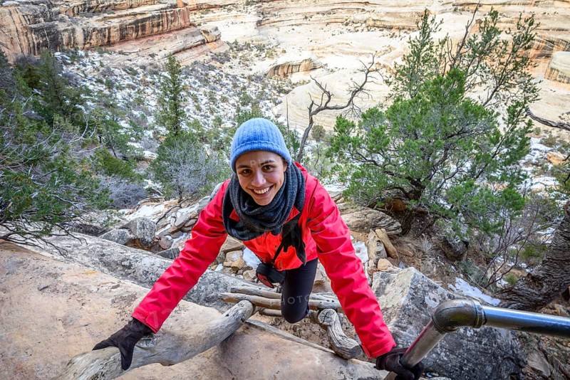 Young woman climbing ladder