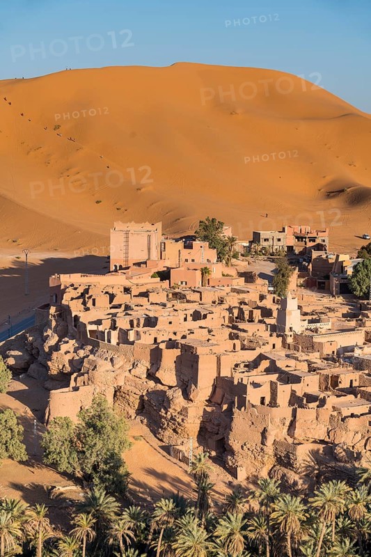 Overlook over the oasis of Taghit with sand dunes