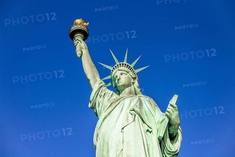 Statue of Liberty in front of blue sky