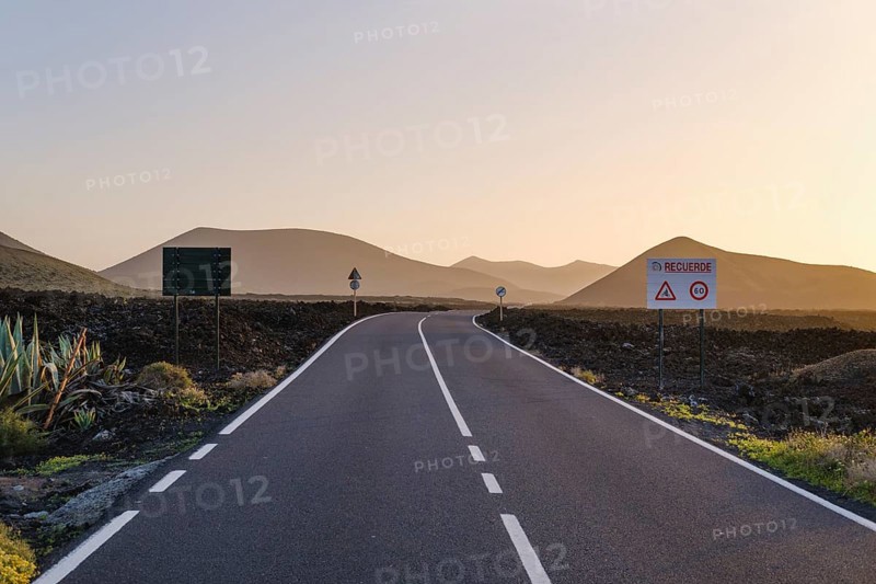 Country road through lava field in evening light