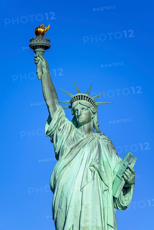 Statue of Liberty in front of blue sky