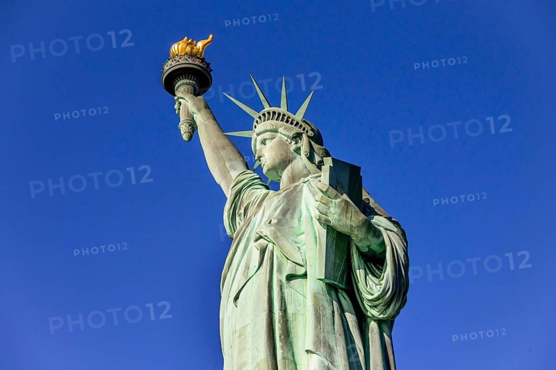 Statue of Liberty in front of blue sky