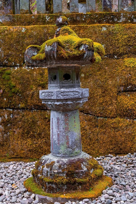 Moss-covered stone candelabra