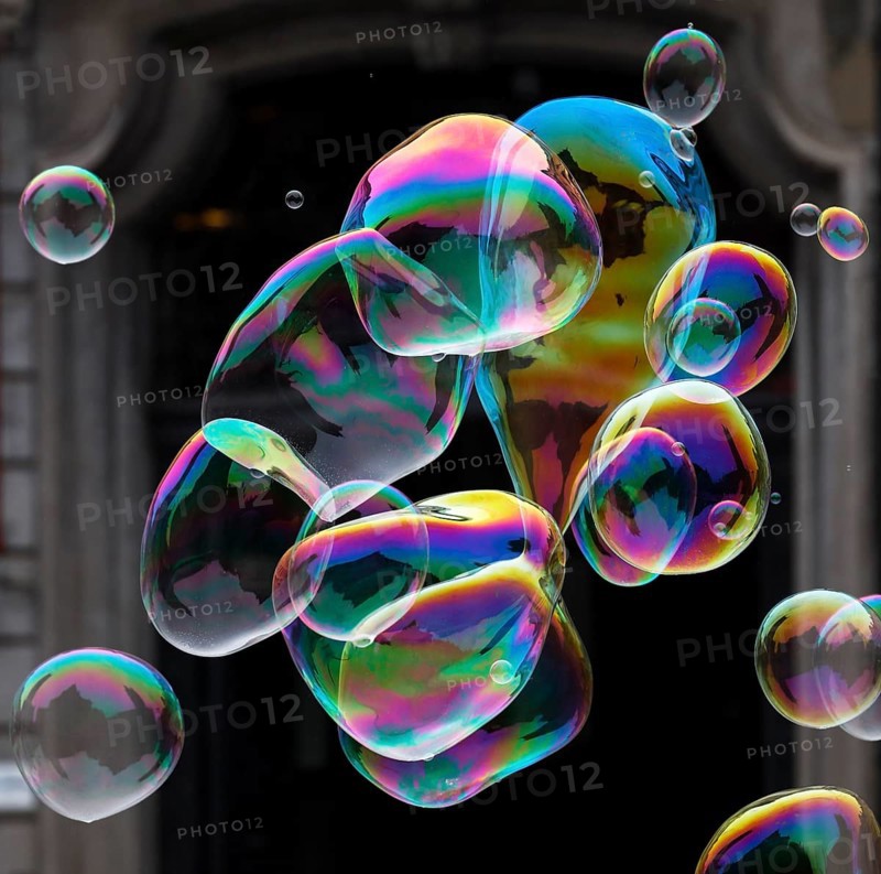 Large soap bubbles fly through the air