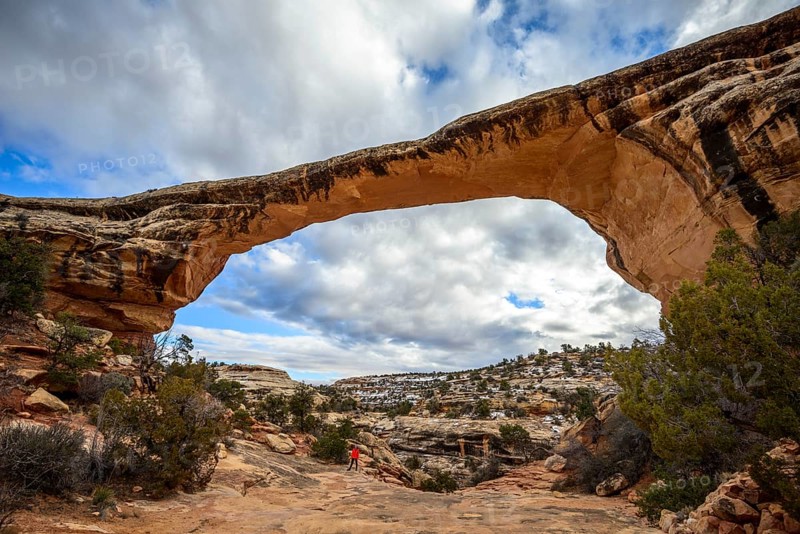 Tourist under rock arch