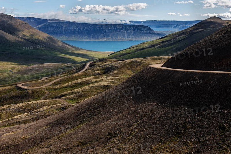 Gravel road meanders through volcanic landscape