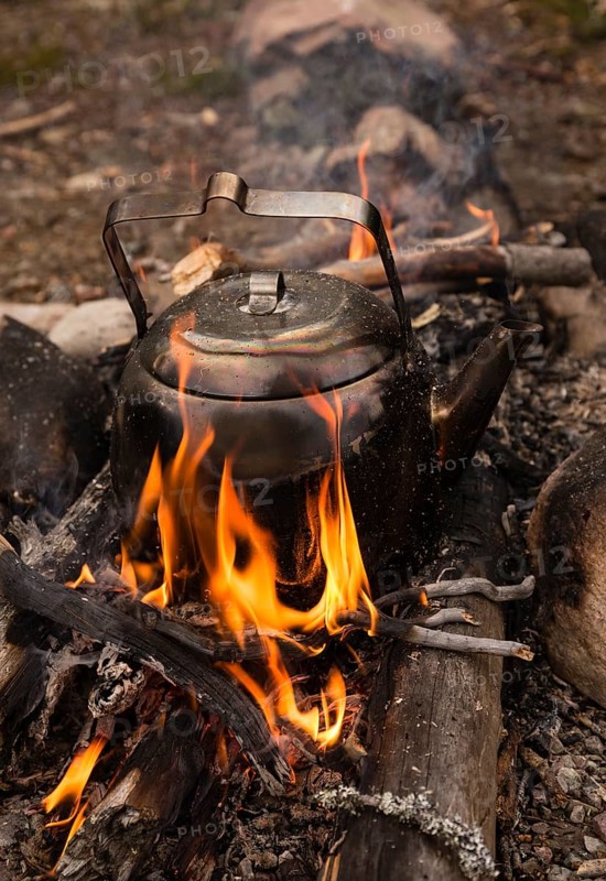 Large sooty coffee kettle on campfire