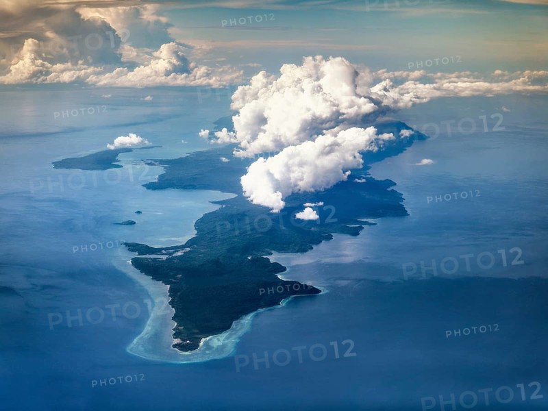 Aerial view south point island Selayar with fringing reef and clouds