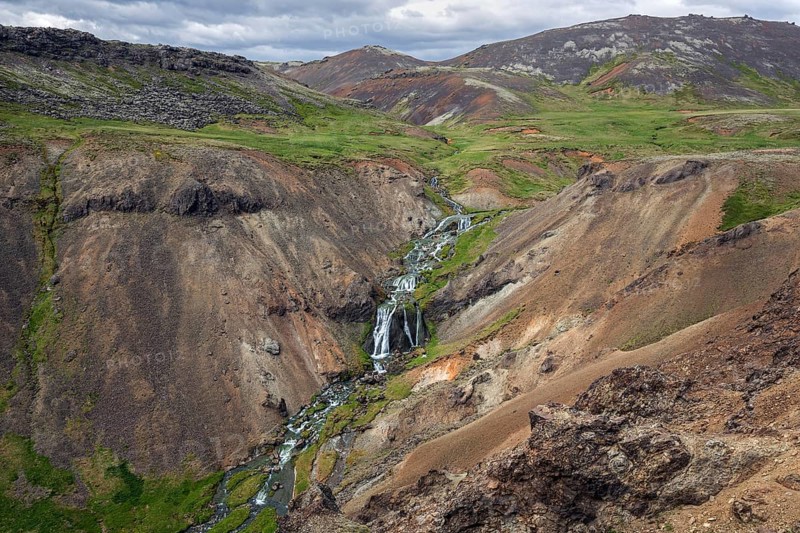 Volcanic landscape and waterfall on the hiking trail to Reykjadalur