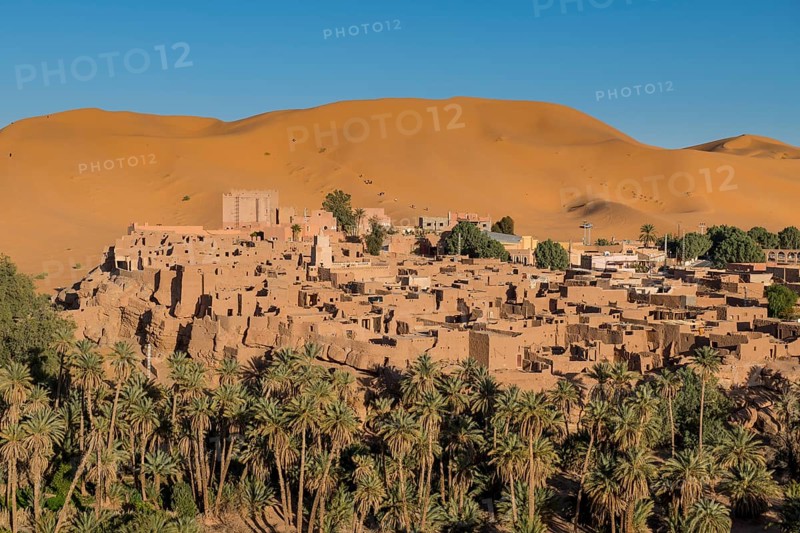 Overlook over the oasis of Taghit with sand dunes