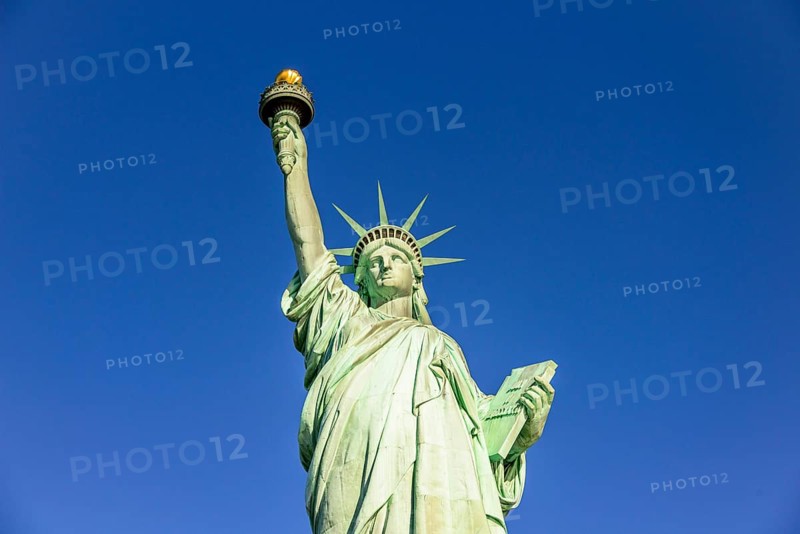 Statue of Liberty in front of blue sky
