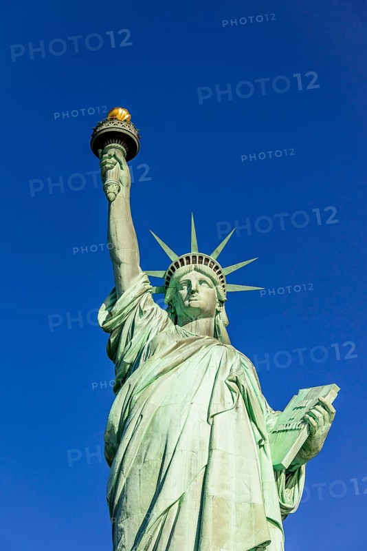 Statue of Liberty in front of blue sky