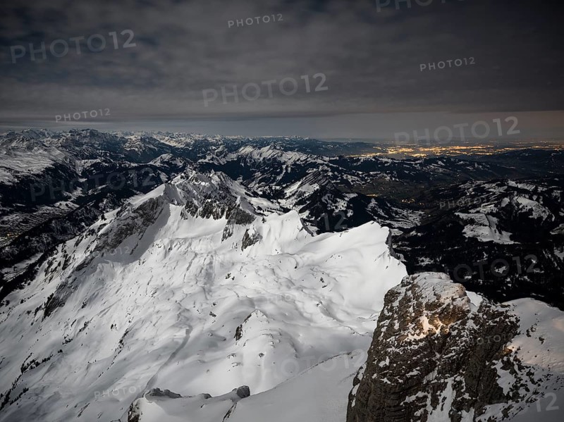 View from Santis to snow-covered mountain landscape at full moon