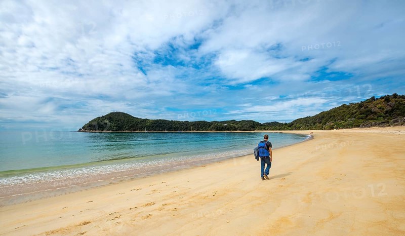 Young man walks on the beach