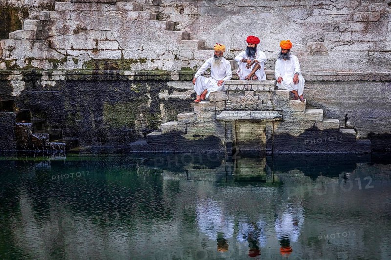 Three men resting at the stepwell Toorji Ka Jhalra in Jodhpur