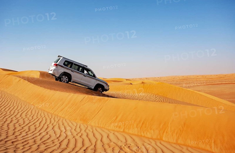 Off-road vehicle drives in the sand dunes