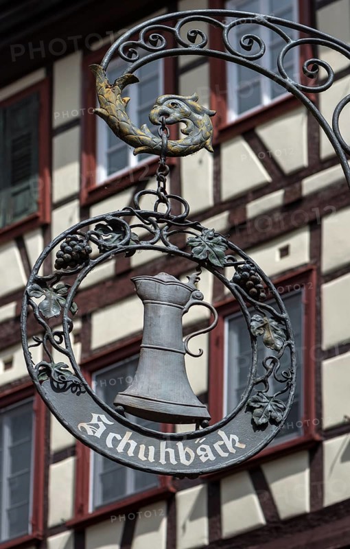 Hanging shop sign with beer mug of an inn