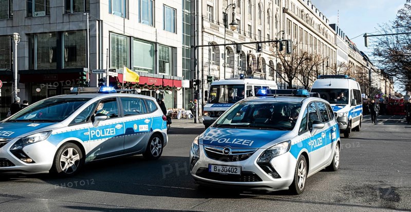 Police cars at the edge of the demonstration