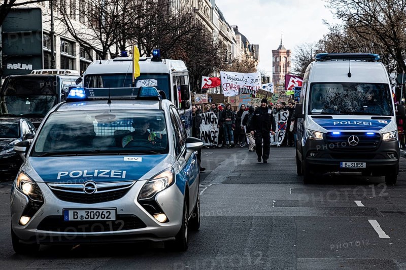 Police cars at the edge of the demonstration