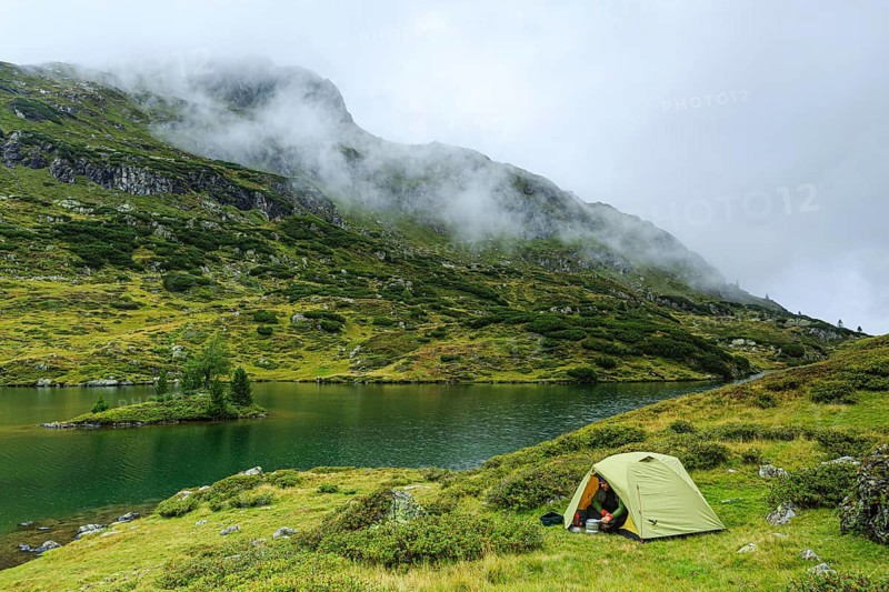 Hiker cooks in front of the tent