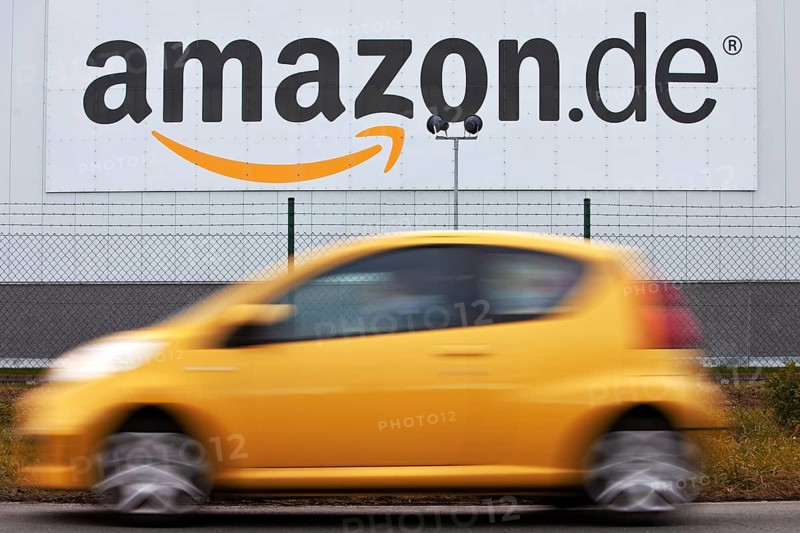 Yellow car in front of Amazon Logistics Center