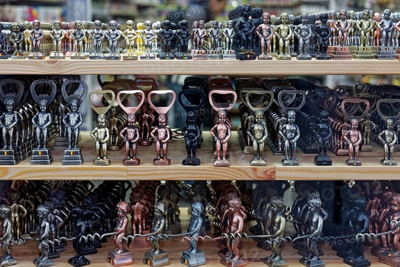 Small Manneken Pis figures as bottle openers and corkscrews in display in shop window