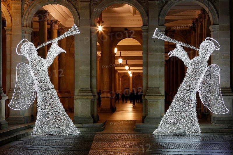 Two angels illuminated for Christmas in front of the Mill Colonnade