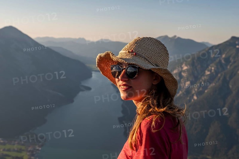 Young woman with sunglasses and sun hat
