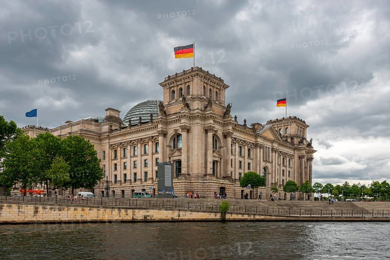 Reichstag with waving German flag at the Spree