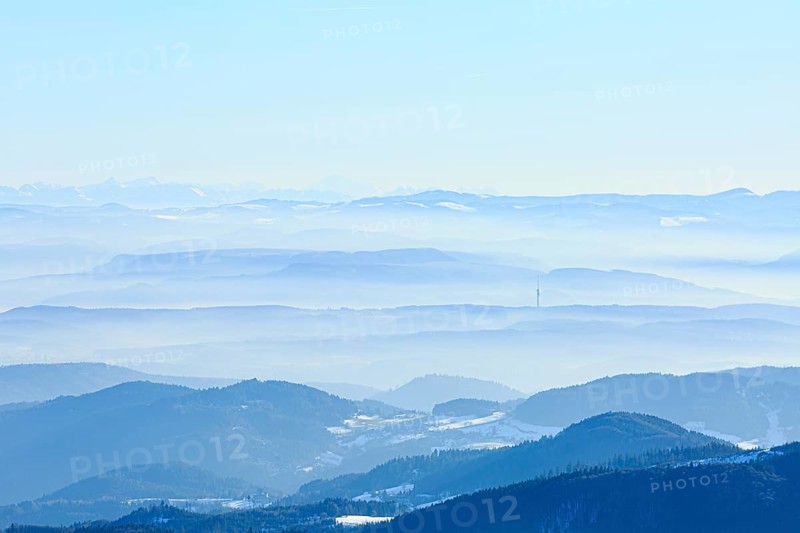 View from the summit of the Belchen to snow-covered mountain and alpine ranges