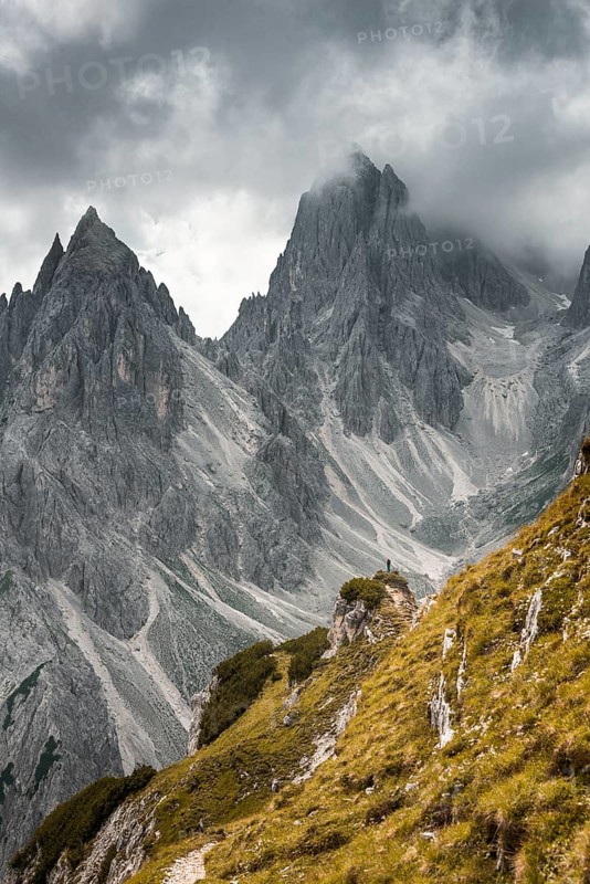 Mountaineer stands on a ridge