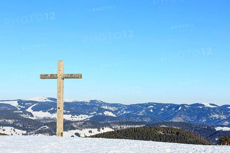 Summit cross of the Belchen in winter with snow