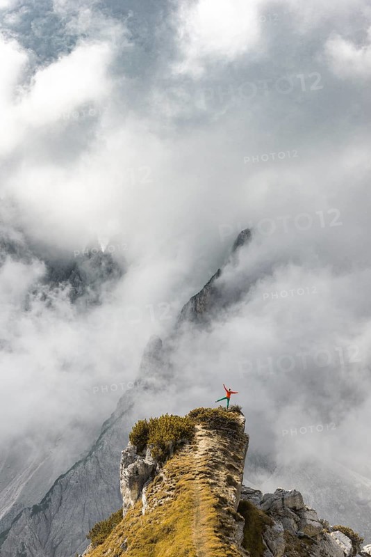 Mountaineer stands on a ridge