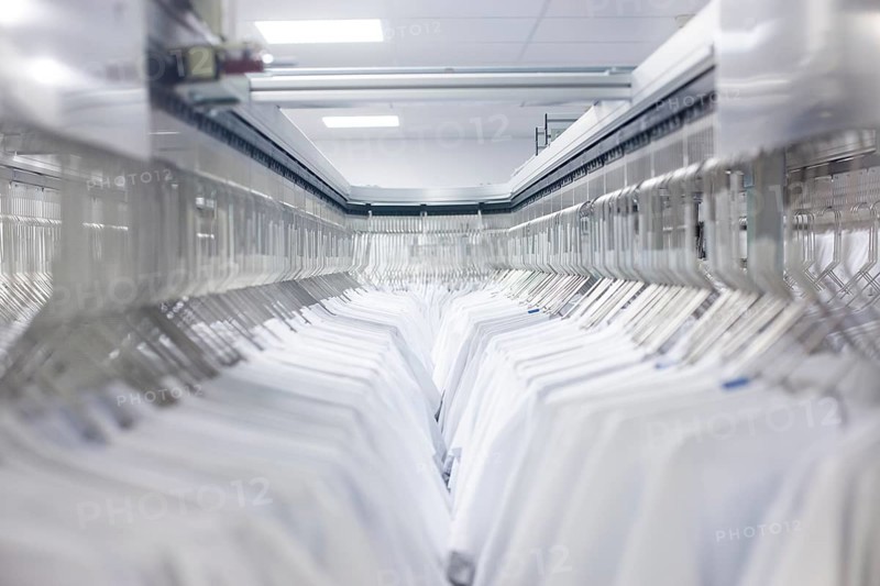 Doctor's coats after cleaning hang in the wardrobe at the hospital