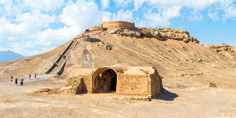 Ruins of ritual buildings in front of Dakhmeh Zoroastrian Tower of Silence