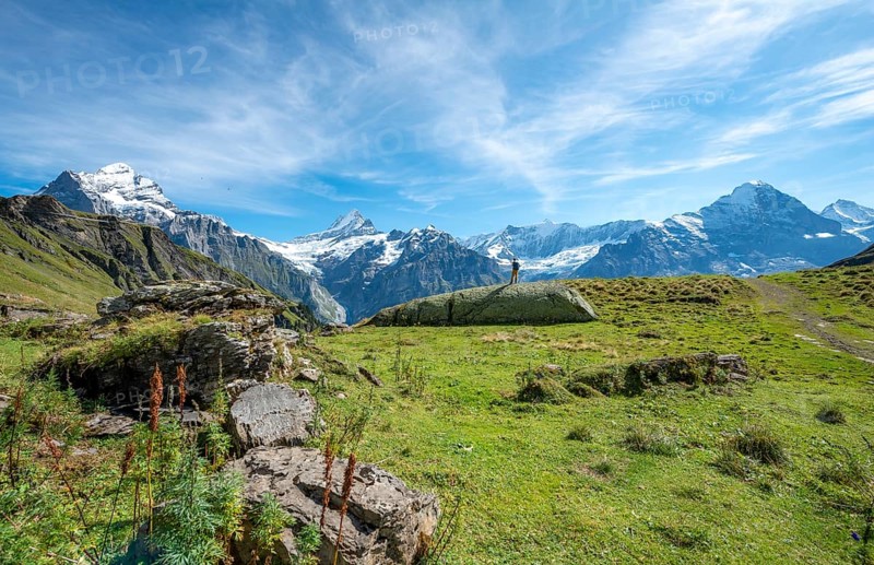 Hiker stands on a large rock