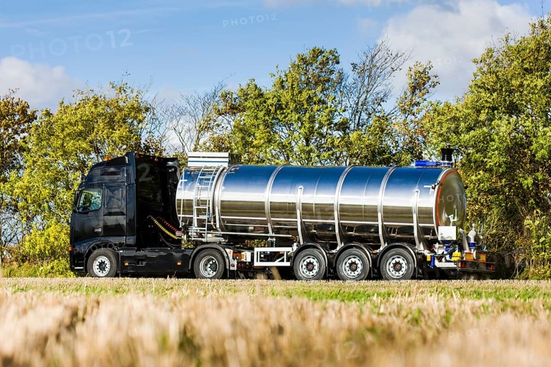 Truck with silo trailer on a dirt road