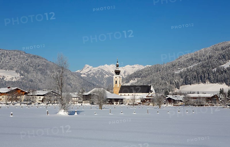 Village with parish church in winter