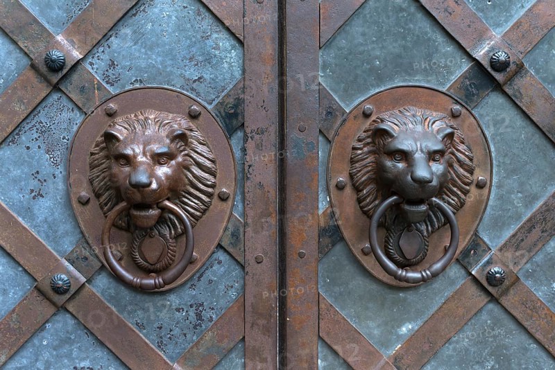 Lion heads as door knockers at the entrance gate of Rabenstein Castle