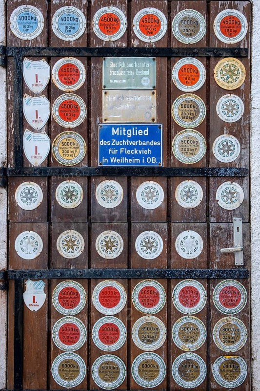 Barn door with many plaques